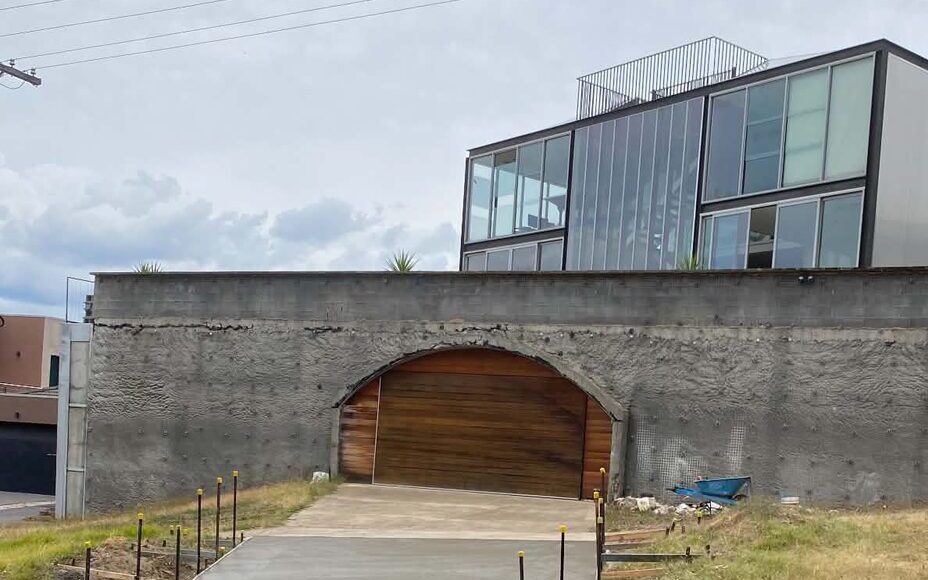 Freshly poured concrete driveway in front of a modern Victorian home